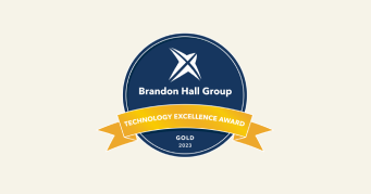 Brandon Hall Group Technology Excellence Award Gold 2023 badge, Award badge featuring blue and yellow design elements.